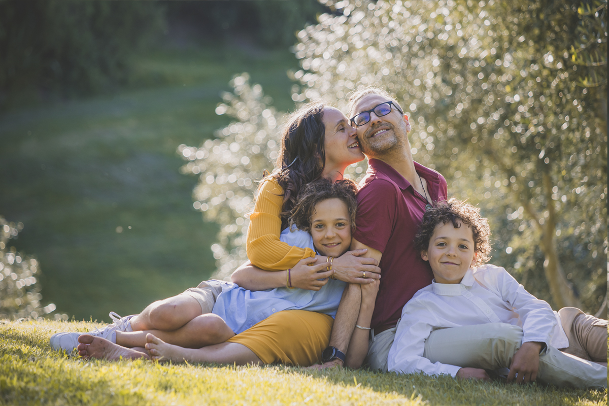 Enjoy stunning Italian scenes everyday, to bring back the memories of your holiday with your family portraits from Italy. Family of four enjoying the olive grove, in a perfect setting for family portraits.