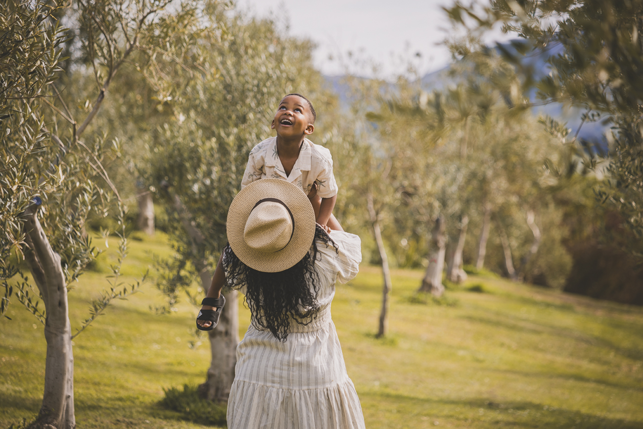 Family Portraits in Italy in an olive grove, young boy with his mother.