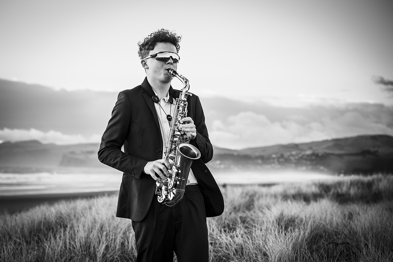 family portraits Christchurch sax player at the beach fundraiser for CSM